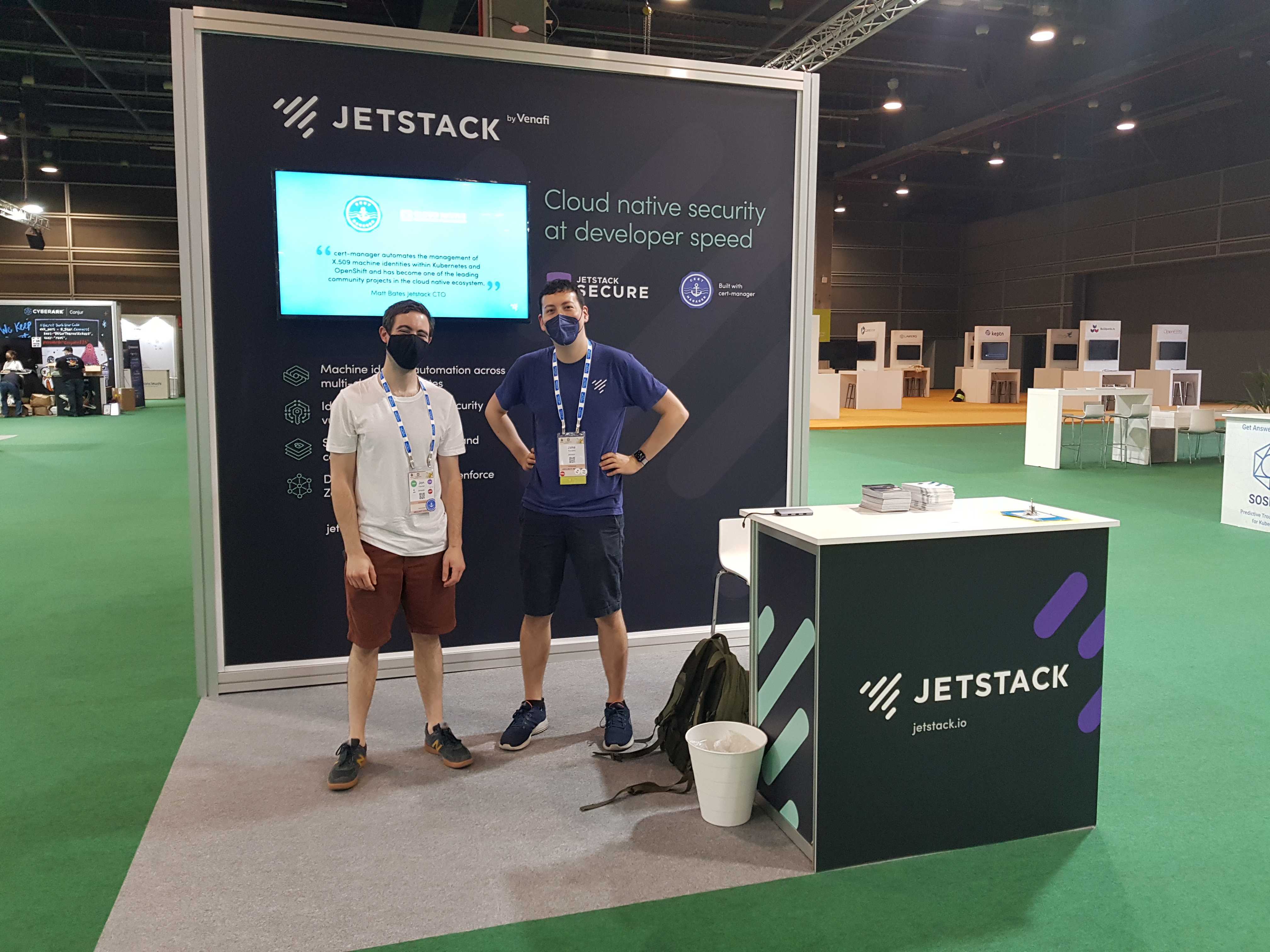 Jake Sanders and Jon Tucher stood infront of the Jetstack conference booth